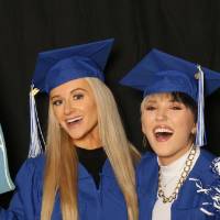 two students using foam finger and pom pom